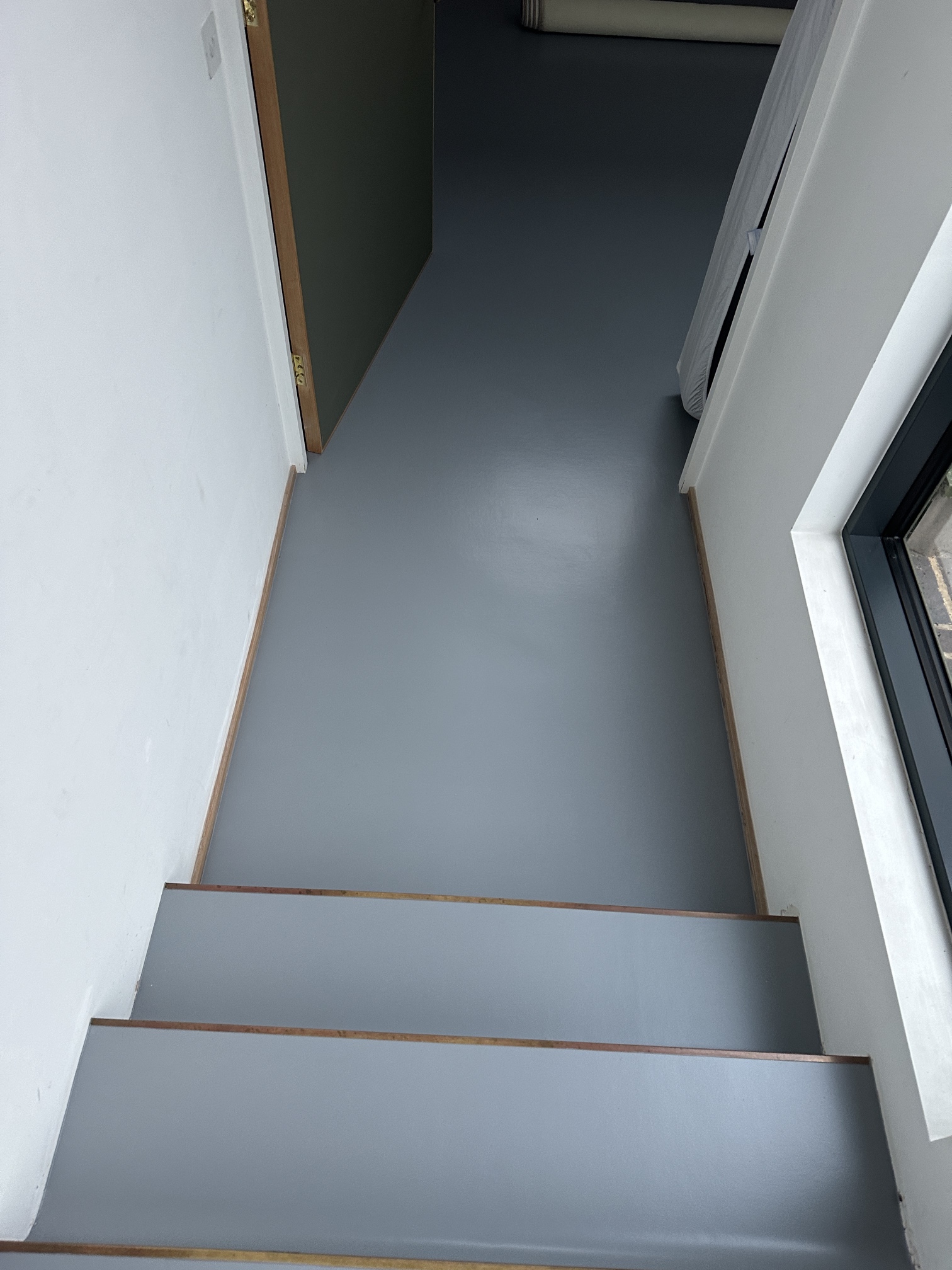 Grey resin flooring on steps and landing in Kennington, South London