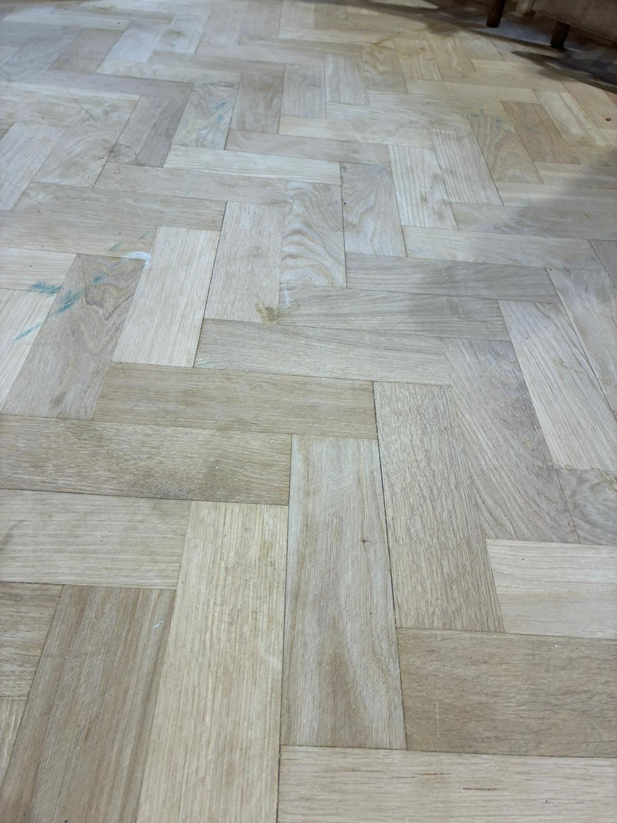 Close-up of sanded oak parquet flooring before finishing in Angel, London