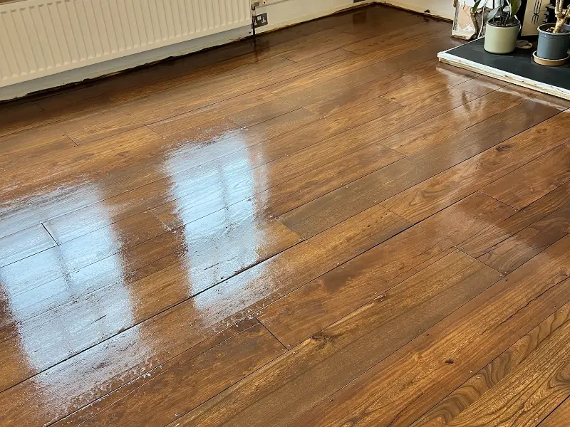 Dark gloss finish on DIY sanded floorboards
