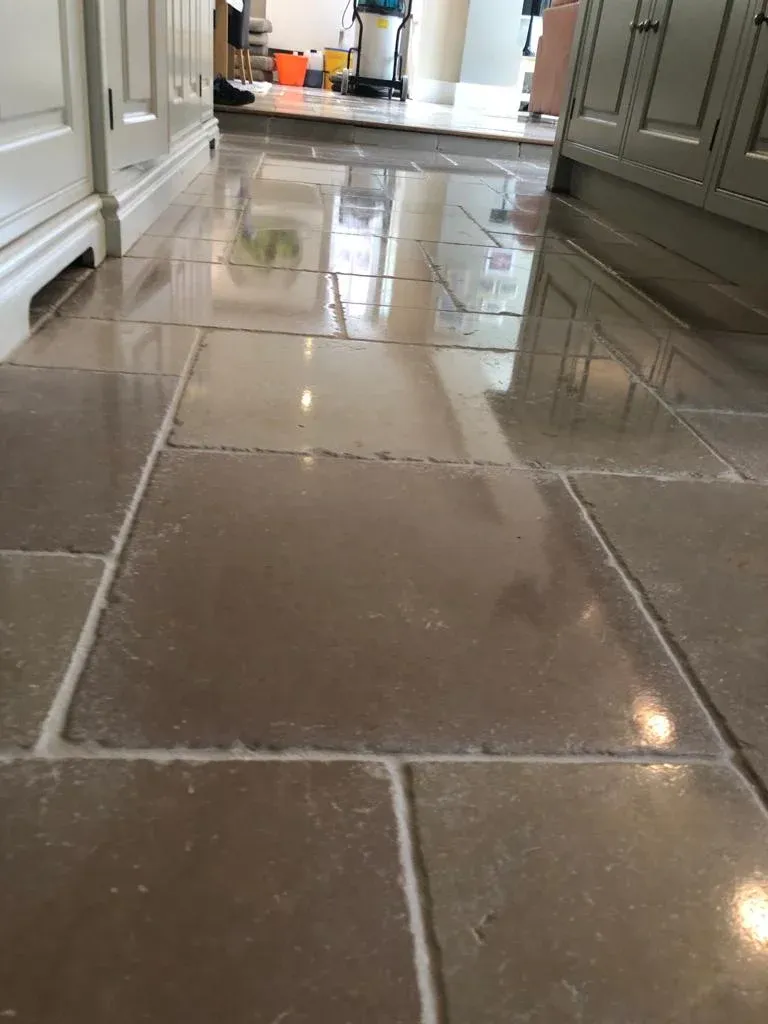High-gloss vitrified limestone floor with reflective, polished finish in a modern kitchen setting.