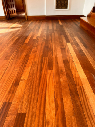 Restored teak floor in Whetstone showcasing its vibrant tones and smooth, flawless surface after expert sanding and finishing.