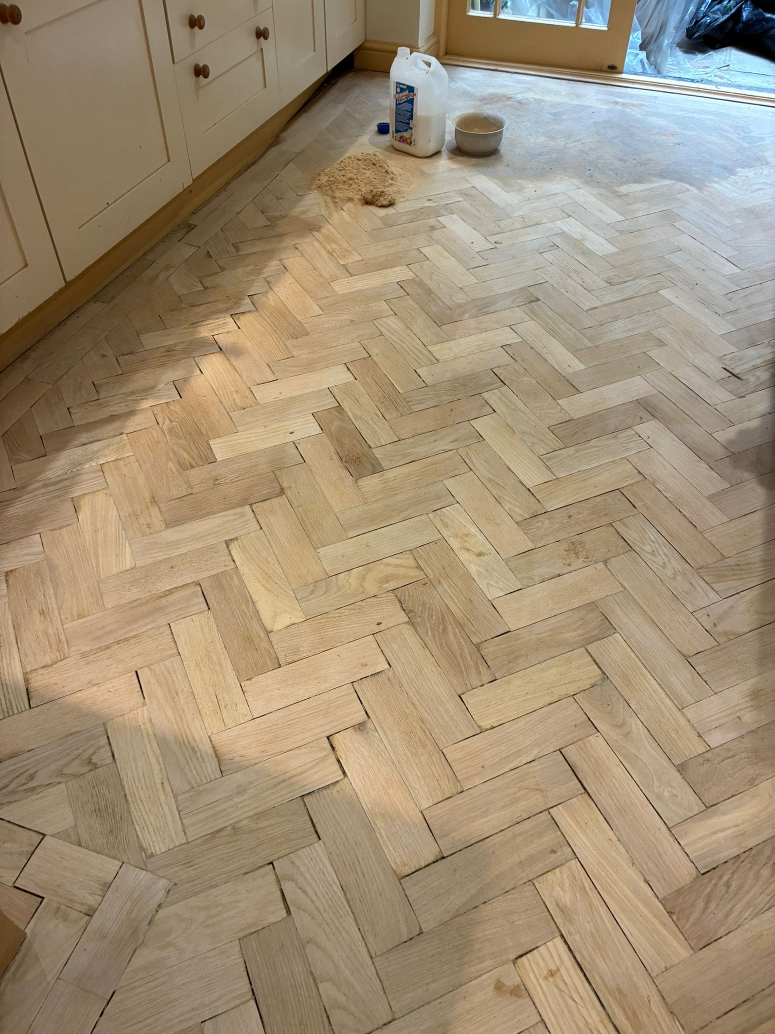 Sanded oak parquet kitchen floor during restoration in Angel, London