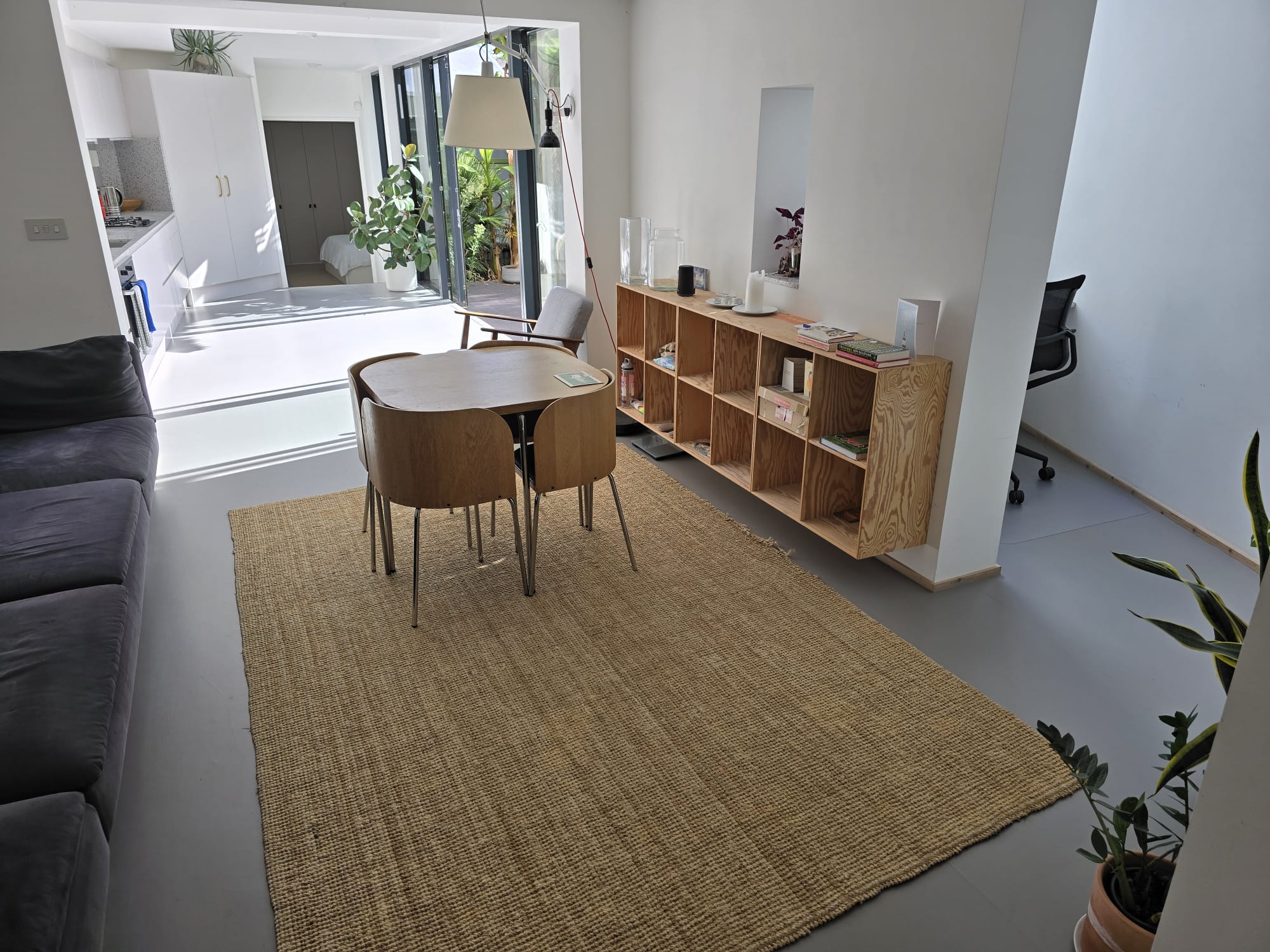 Wide view of the grey marmoleum floor in a modern Kennington home before stain treatment and recolouring