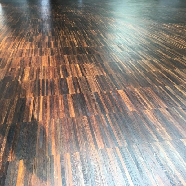 Dark-stained wooden floor showcasing custom oiling options for a bold and unique finish.