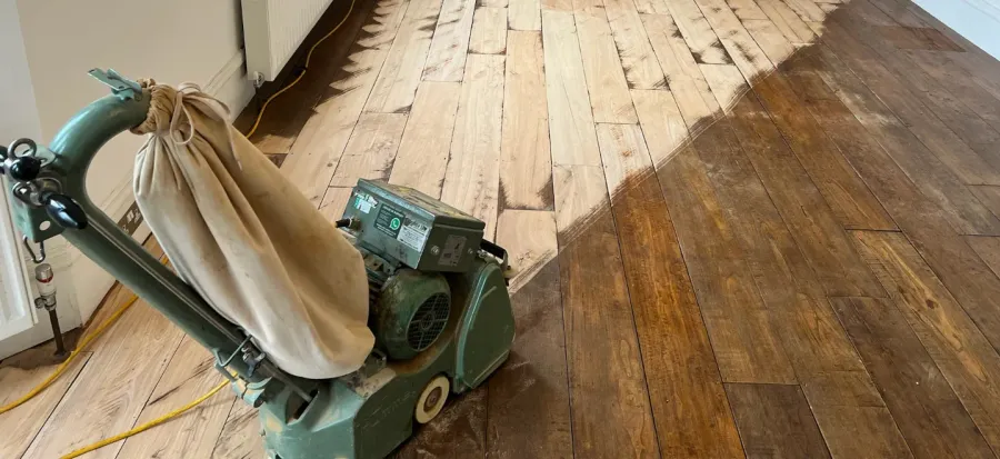 Dust-free floor sanding in progress on a wooden floor in London, showing the dramatic before and after difference.