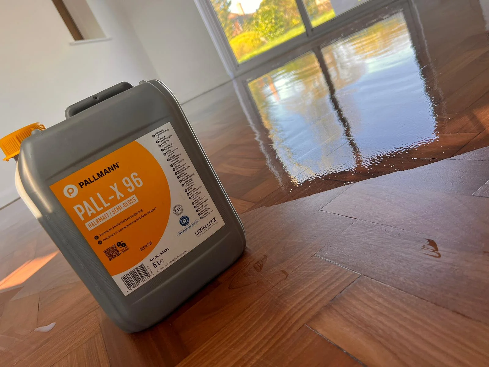 Application of Pall-X 96 semi-gloss lacquer on a restored teak herringbone floor in Berkhamsted