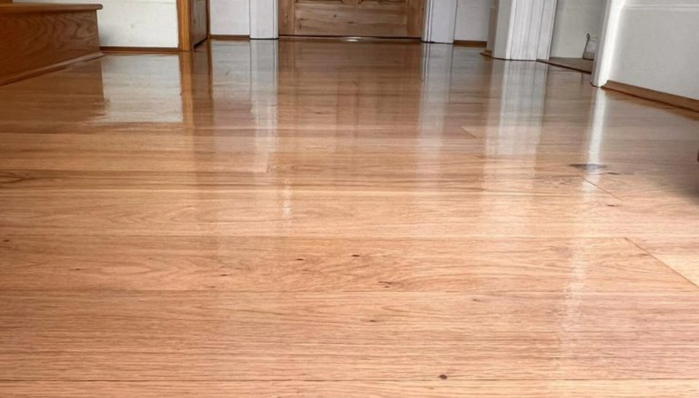 A low-angle view of an oak floor in Wanstead, London, showing the sanding process with Pall-X 96 lacquer.