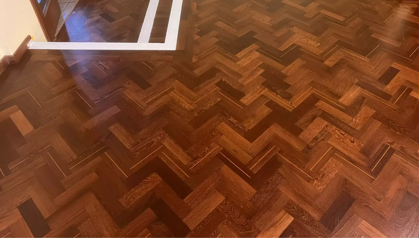 Freshly sanded and primed Wenge hardwood floor in Heston church, showing rich grain clarity and uniform matte surface