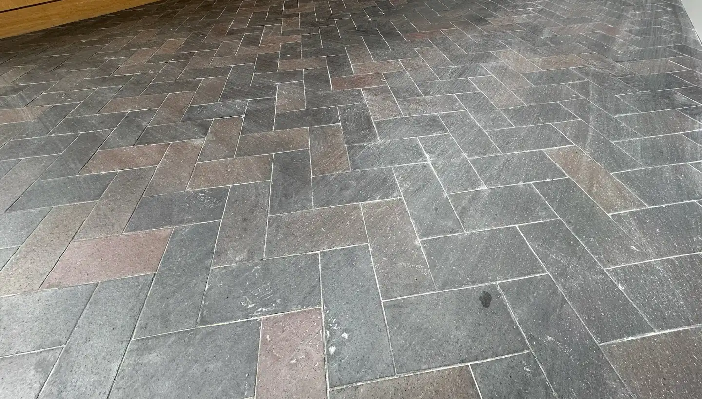 Unsealed blue brick ceramic floor with residue and builder dust