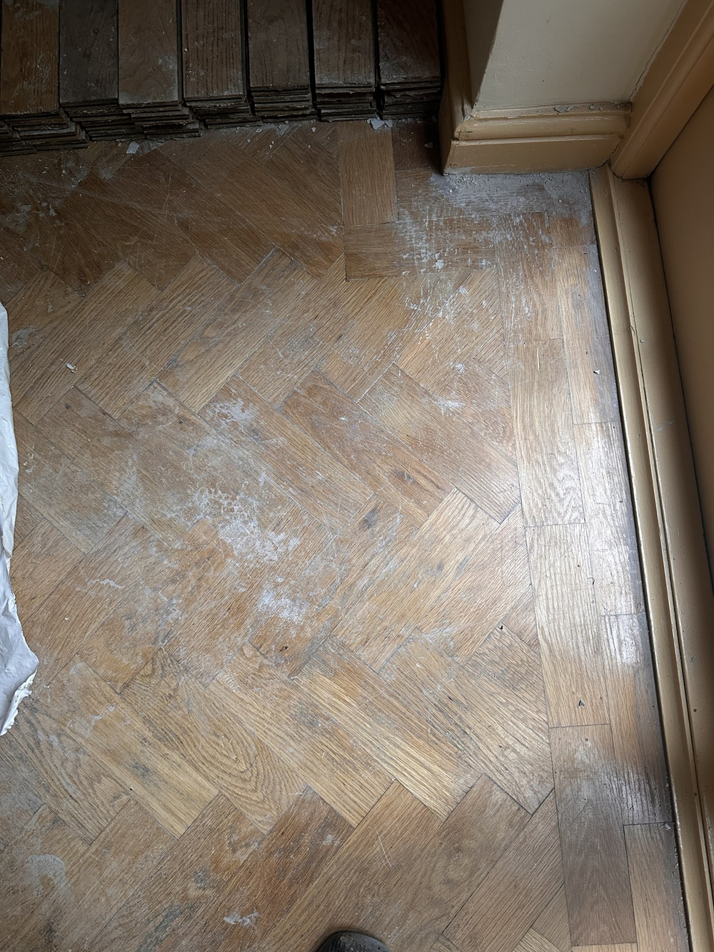 Oak parquet kitchen floor before sanding and restoration in Angel, London