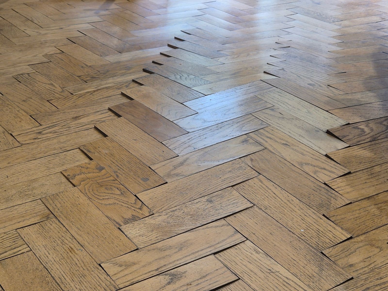 Oak parquet blocks lifting before floor repair in Angel, London