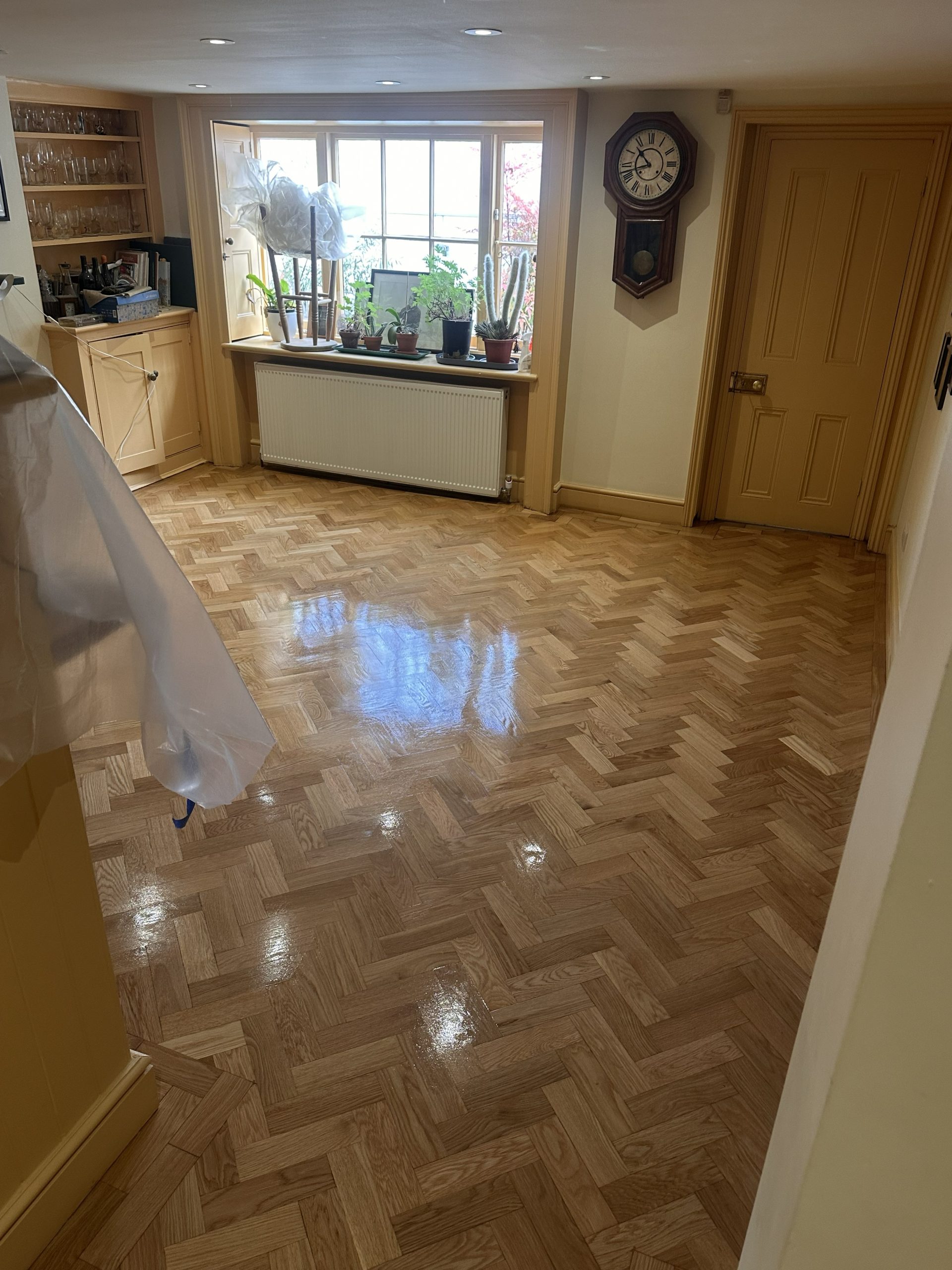 Wide after photo of restored oak parquet flooring in Angel, London
