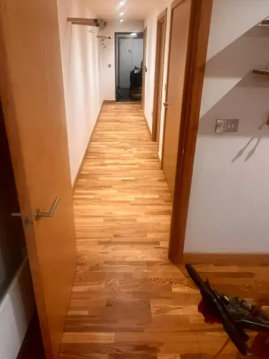 Oak floor sanding and restoration in Fish Islands, Stratford, London, showcasing a hallway with beautifully revitalized wood flooring.