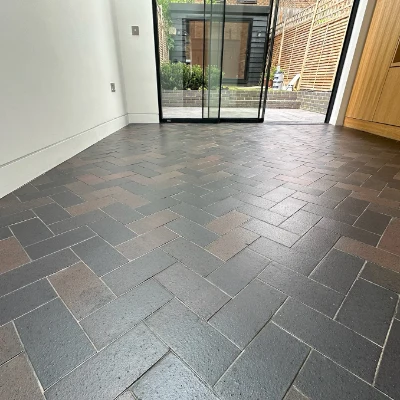 Restored blue brick ceramic floor with seamless flow to outdoor garden patio