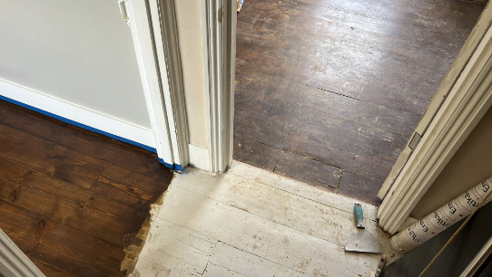 Comparison of a newly restored wooden floor with a stained and lacquered finish versus the old, worn-out floor in Tooting.
