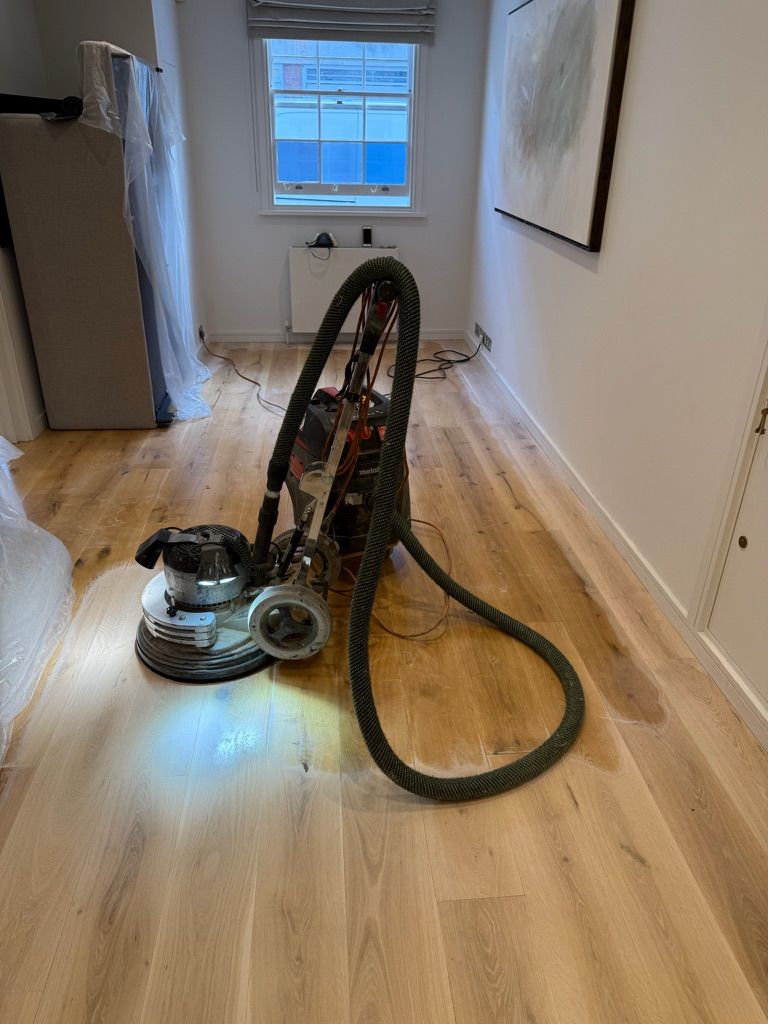 Oak floor sanding equipment in a London hallway