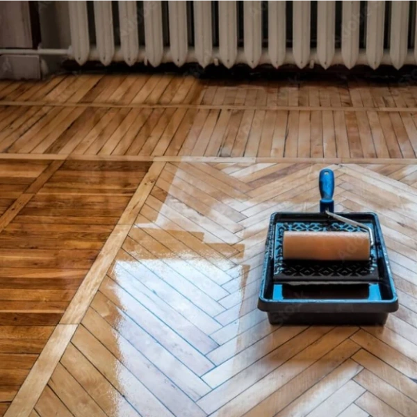 lacquer finish on wooden floor. Application with a roller head