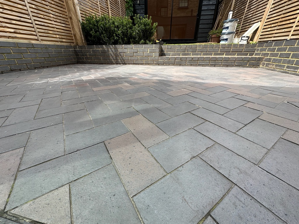 Blue brick ceramic patio floor cleaning in a Kentish Town garden.