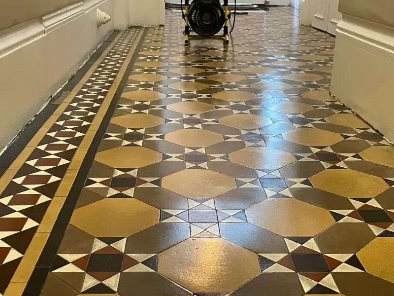 Restored Victorian tiles in Kensington with vibrant colours, intricate geometric patterns, and a glossy protective finish.