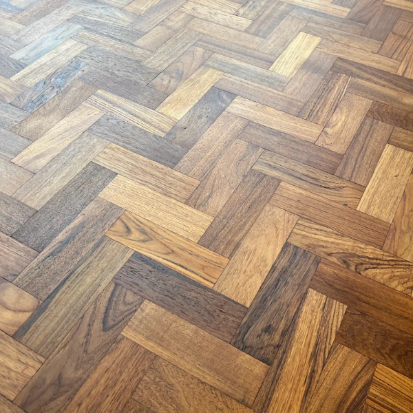 Close-up of a well-maintained parquet floor with a smooth, polished finish, showcasing the beauty of regular care and protection.