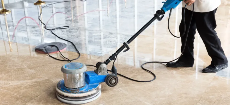 Marble floor being restored by a professional technician using a rotary buffer
