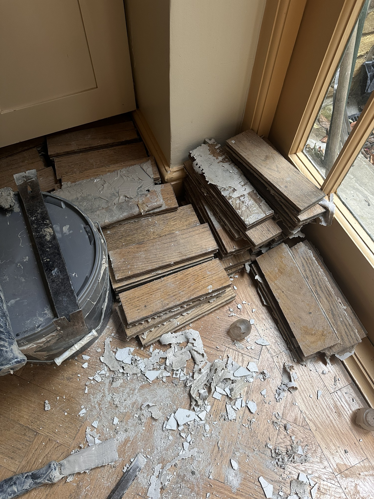 Lifted oak parquet floor blocks during kitchen floor restoration in Angel, London