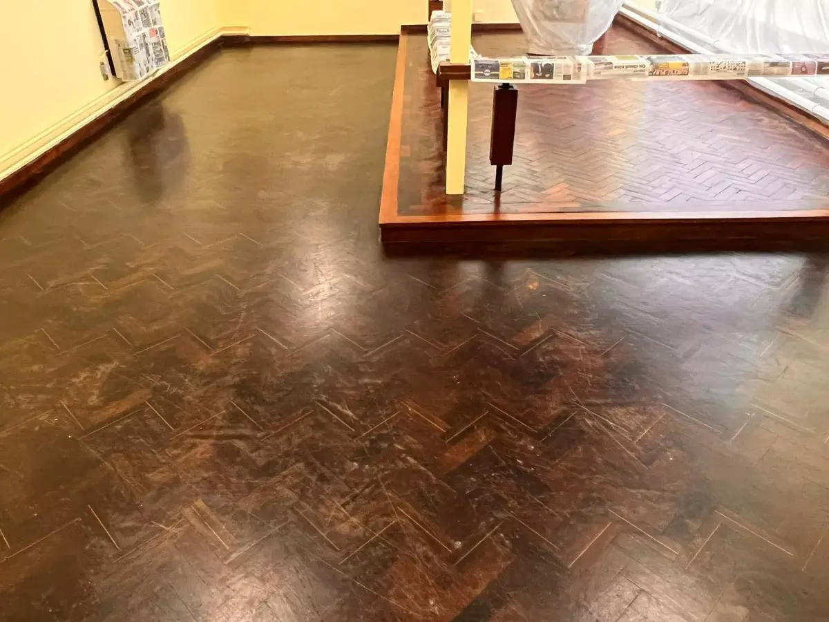 Scratched Wenge wood floor around church altar prior to restoration work