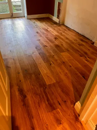 Fully restored oak floor in Highbury, showcasing a rich, warm finish after professional sanding and oiling by Silver Lining Floor Care.