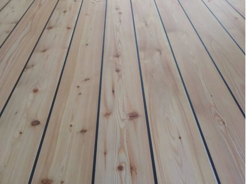 Black gap filled pine floorboards