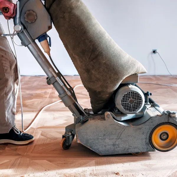 Professional wood floor sanding machine in use on herringbone flooring in Chelsea by experienced floor restoration contractor