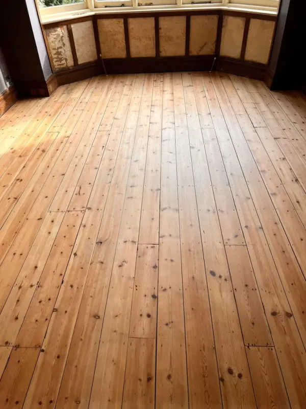 Restored pine floorboards in Woodford Green, London, after professional sanding and Pall-X Pure finishing.