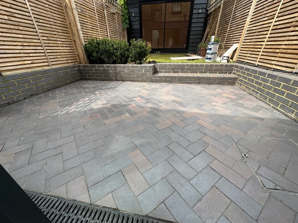 Garden blue brick ceramic patio floor restoration at a Kentish Town property.