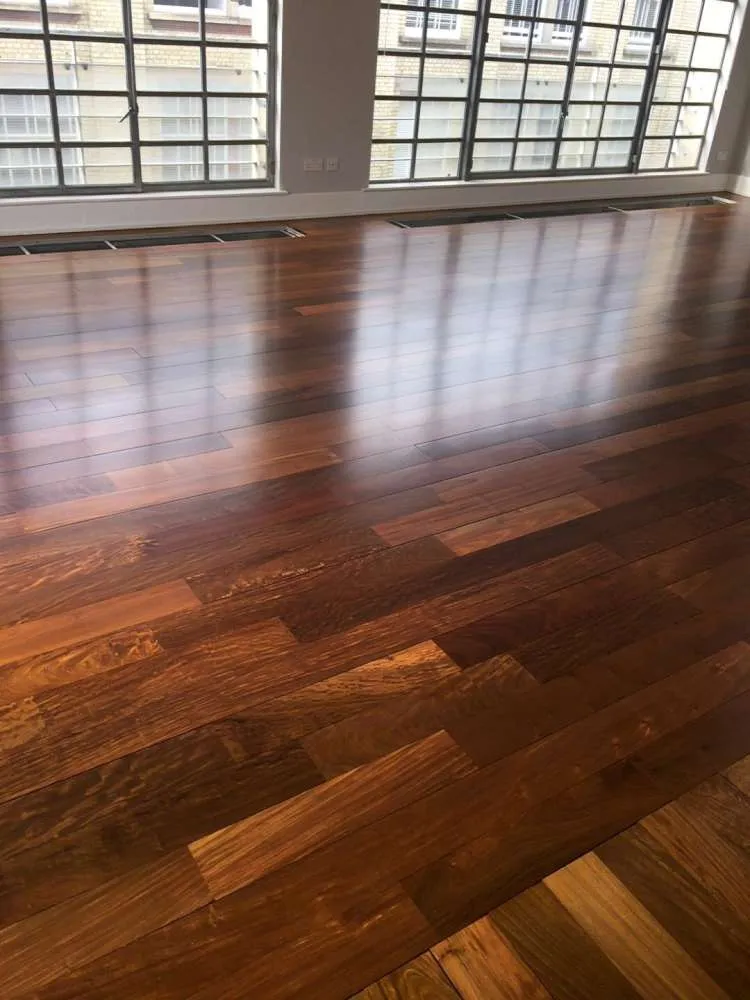 Completed Ipe Lapacho wood floor with a flawless, glossy finish in a London property, following the application of Pallmann Allbase primer and Pall-X 98 lacquer.