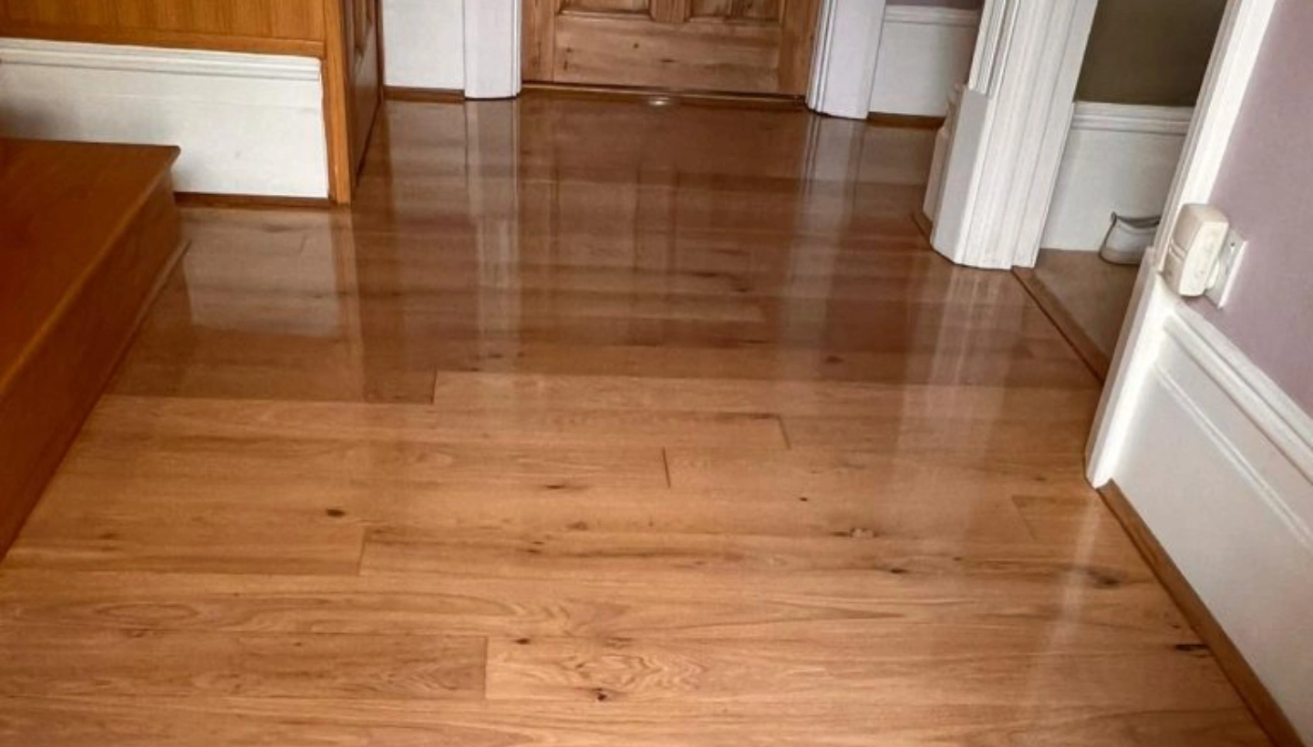 Oak floor in Wanstead, London, before sanding and lacquering, showing its original worn surface.