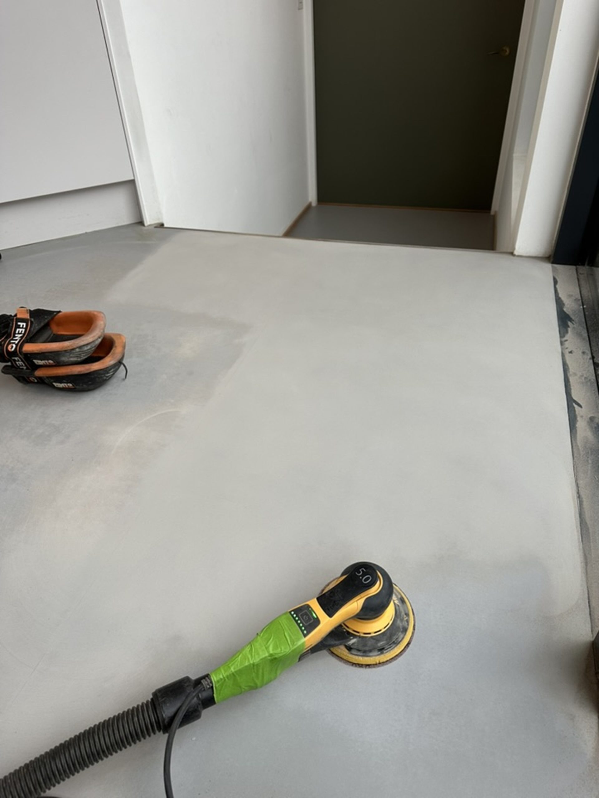 Sanding and preparation of a resin floor before repair in Kennington, South London