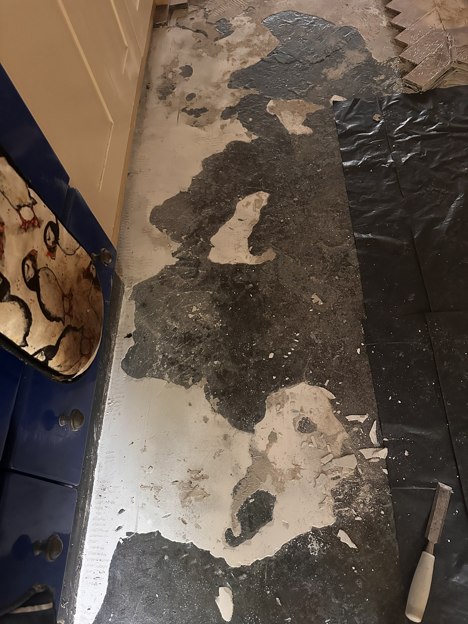 Kitchen subfloor exposed after parquet floor removal in Angel, London