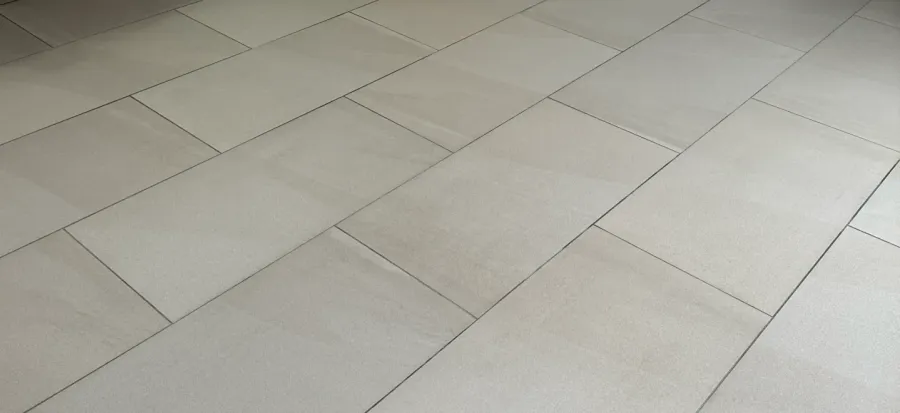 Close-up of textured light porcelain tiles after professional cleaning in London