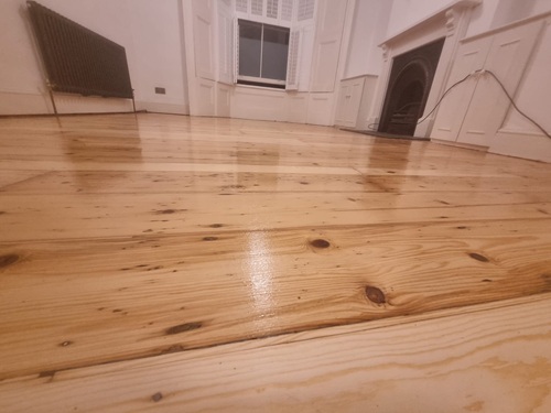 Close up of restored pine floorboards showing natural grain and knots in London home
