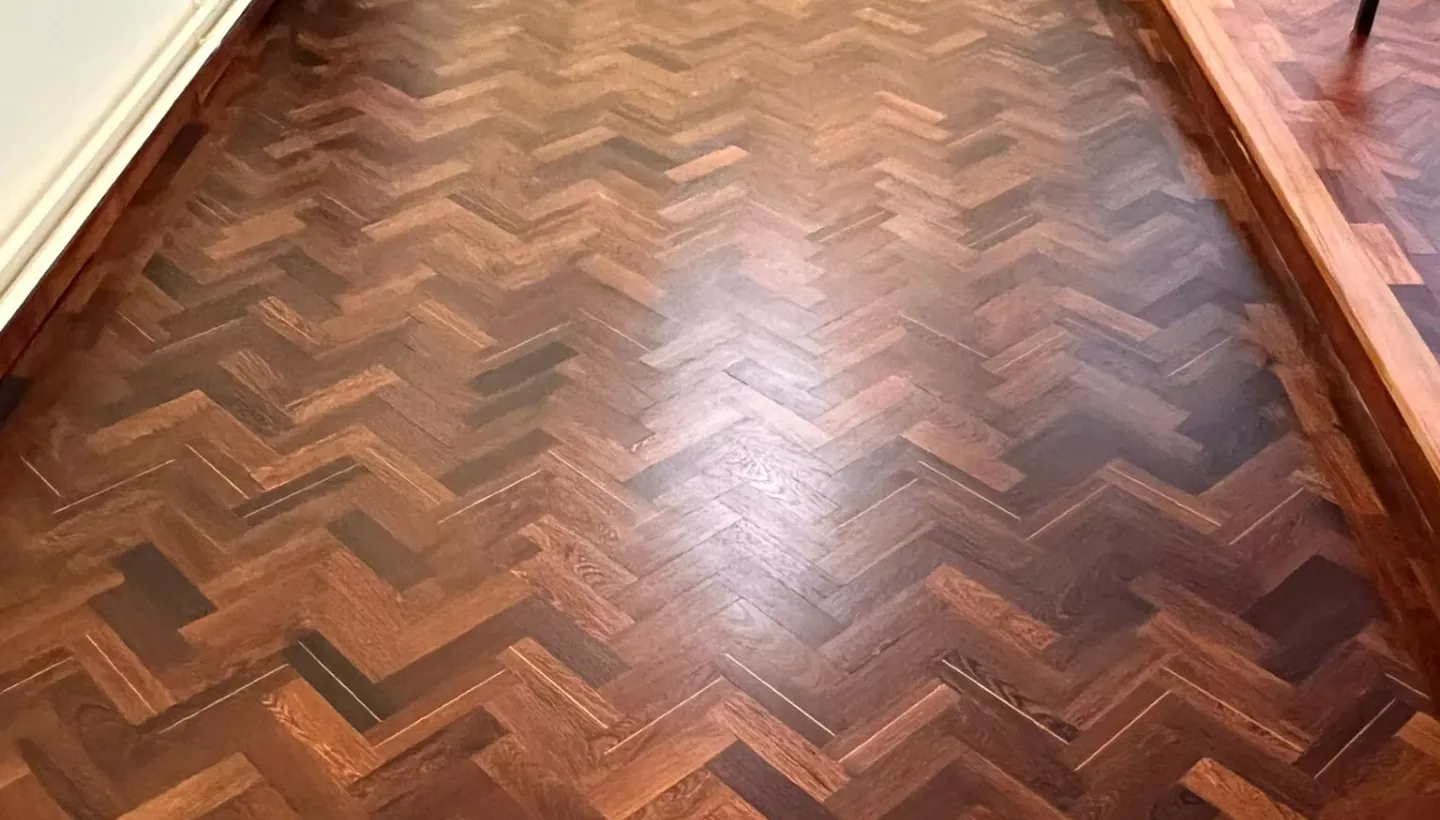 Refinished Wenge wood floor in a church with a smooth matte Pall-X 98 lacquer finish showing rich grain and dark tones