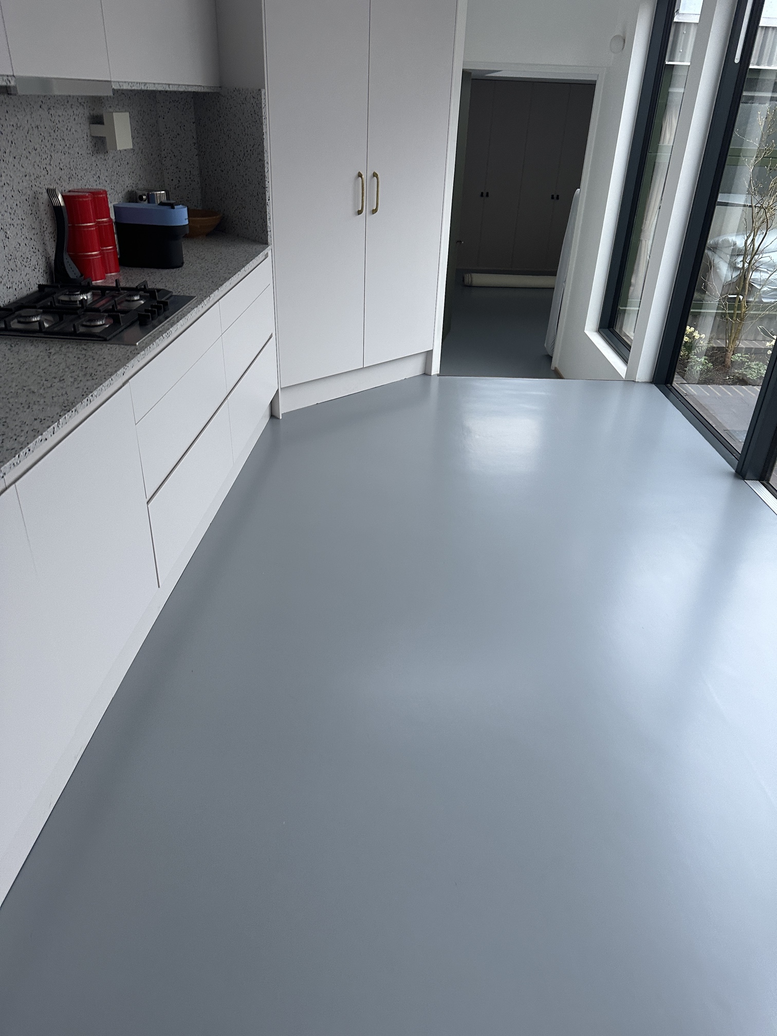 Finished grey resin kitchen floor in a modern home in Kennington, South London