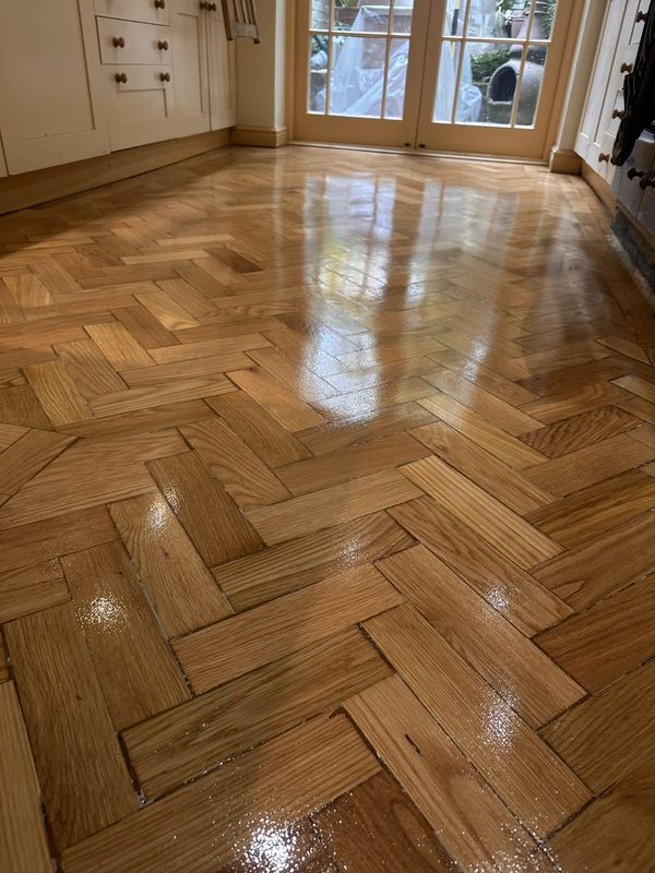 Close-up of refinished oak parquet flooring with a glossy finish in Angel, London