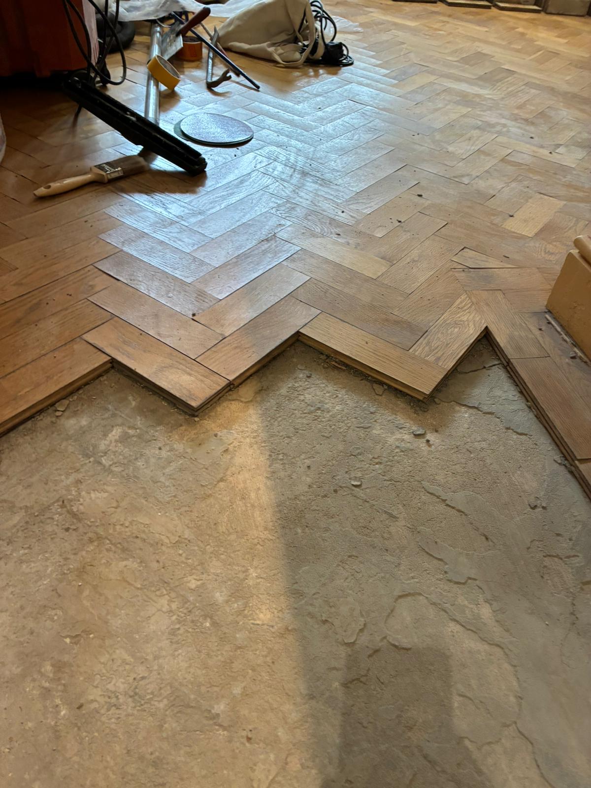 Oak parquet repair detail along floor edge in Angel, London