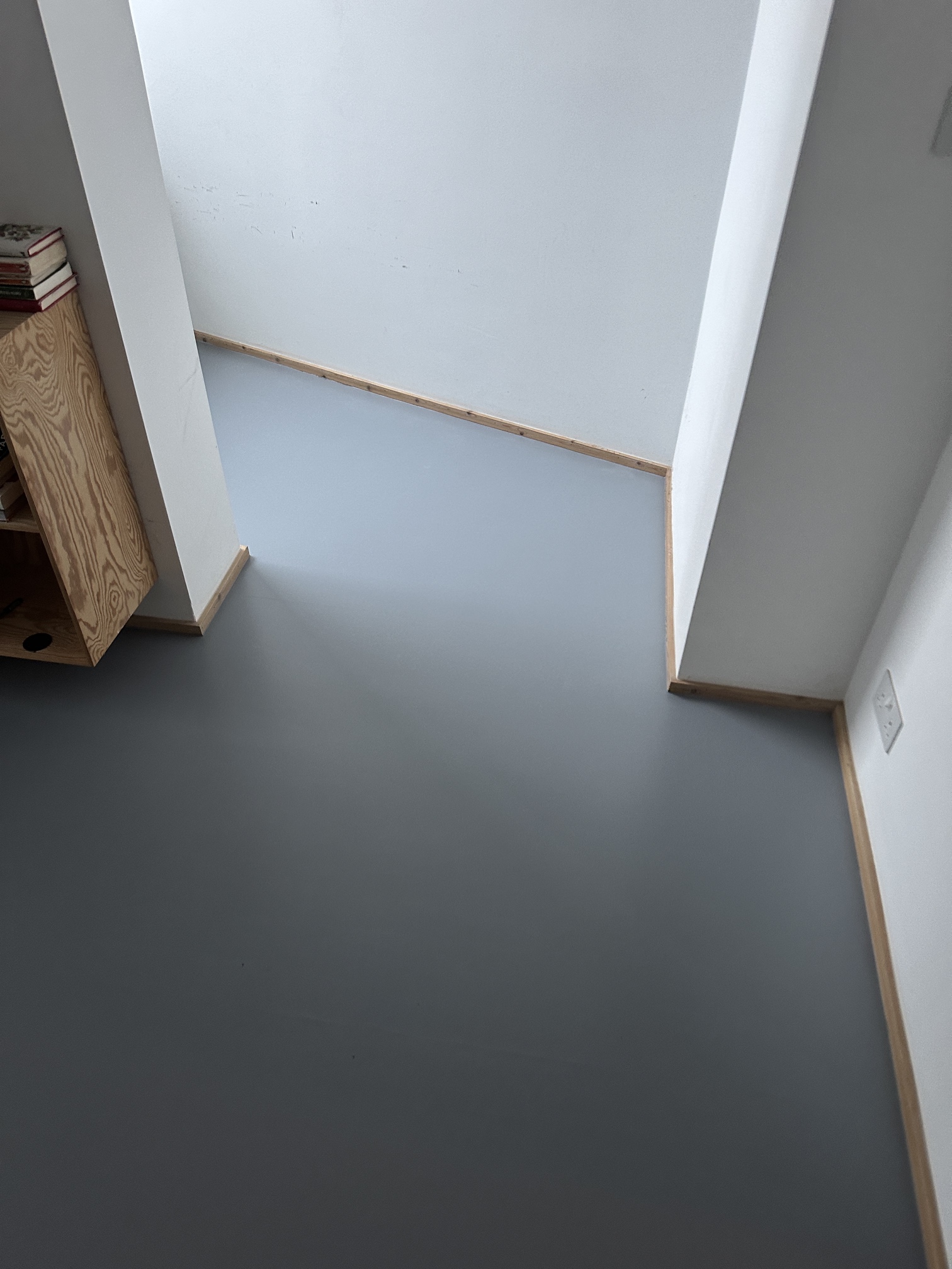 Finished grey resin floor alcove in a Kennington small room, south London