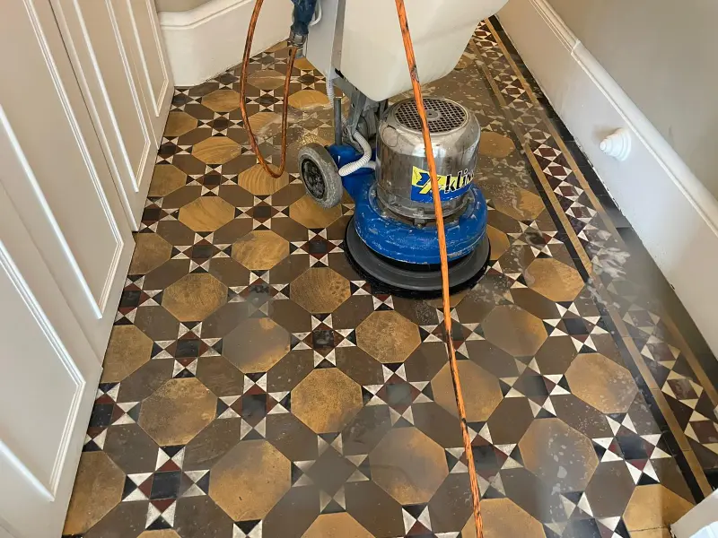 Deep cleaning of Victorian tiles in Kensington using professional equipment to remove dirt and restore their original vibrancy.