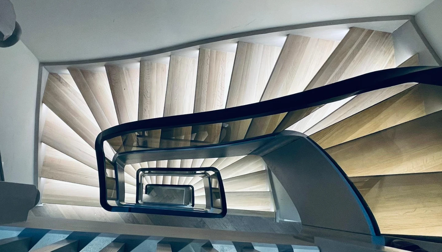 A precisely sanded oak staircase in Kensington, showcasing smooth, even wood grain preparation for staining and finishing.
