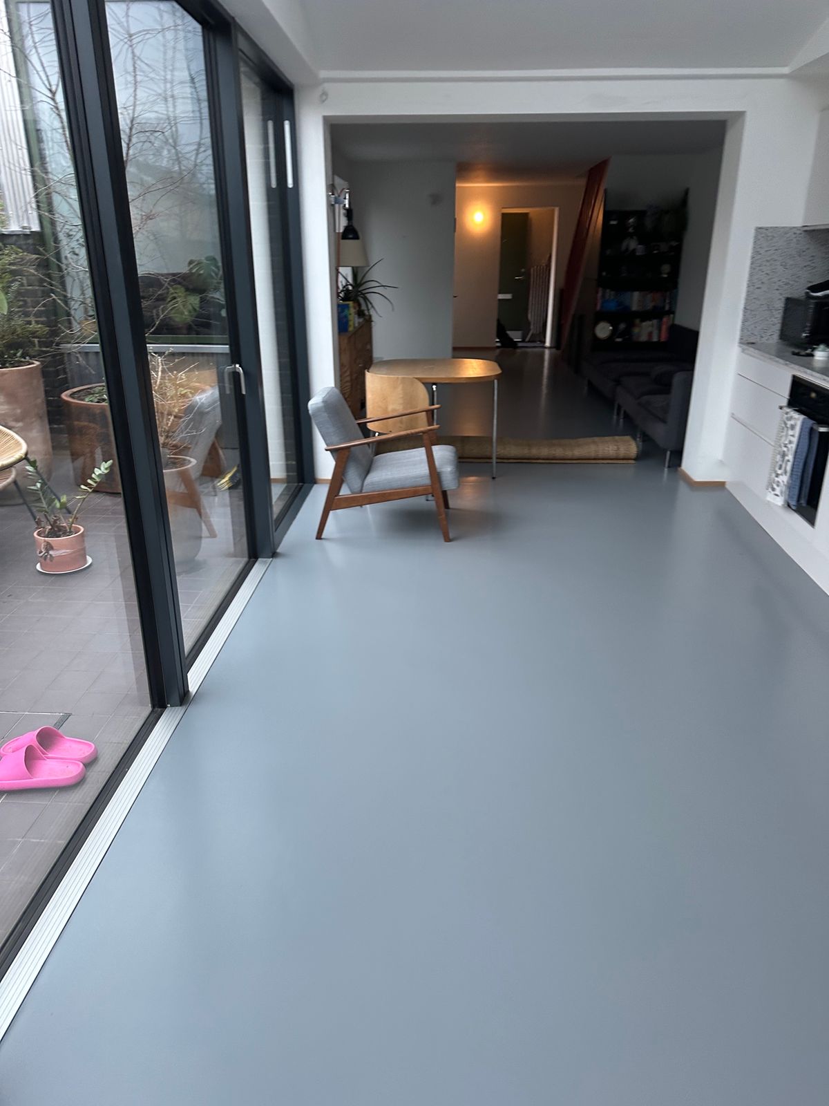 Open-plan room with restored grey floor after recolouring and sealing in Kennington South London