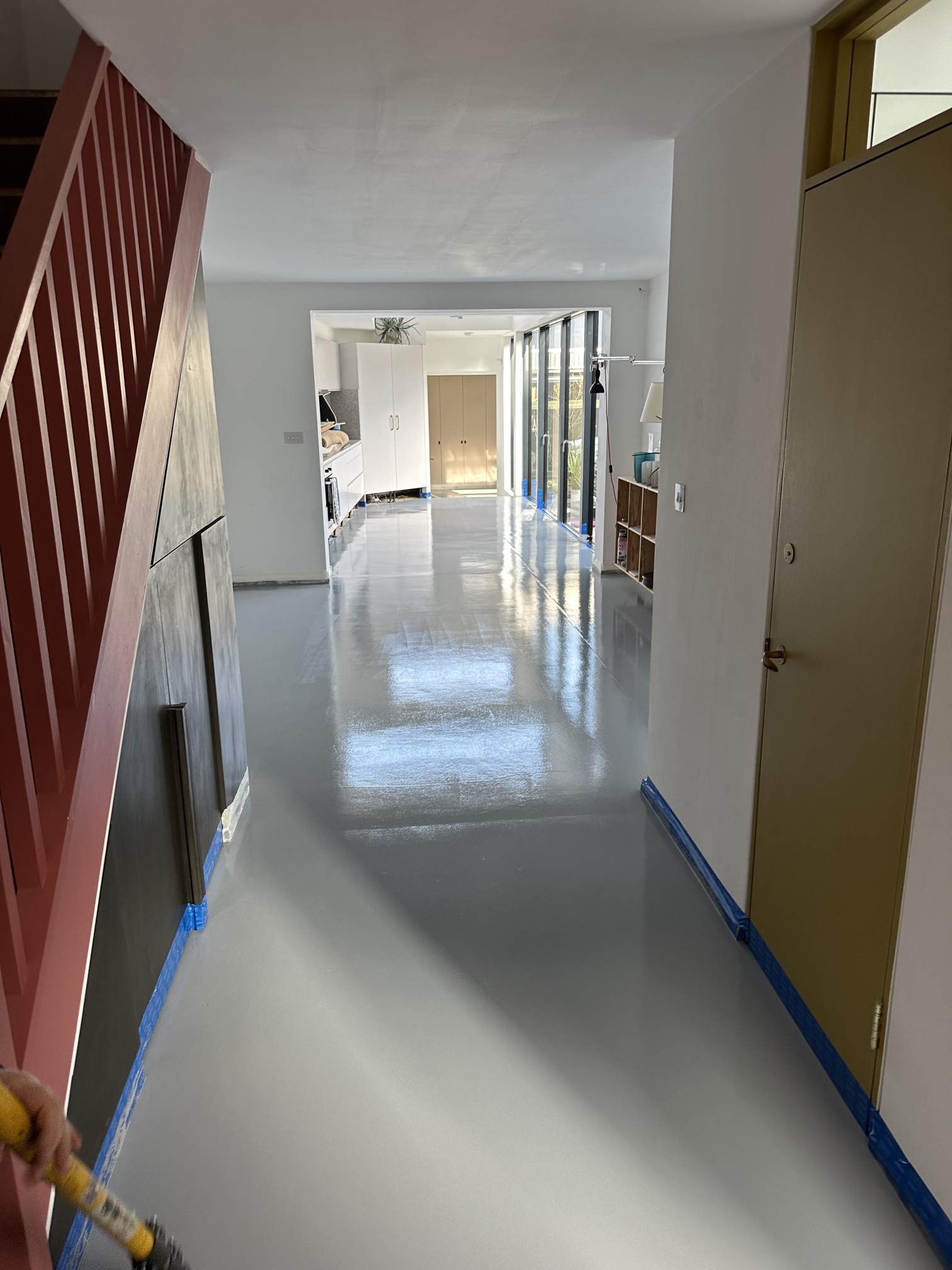 High-gloss grey resin floor finish in hallway in Kennington, South London