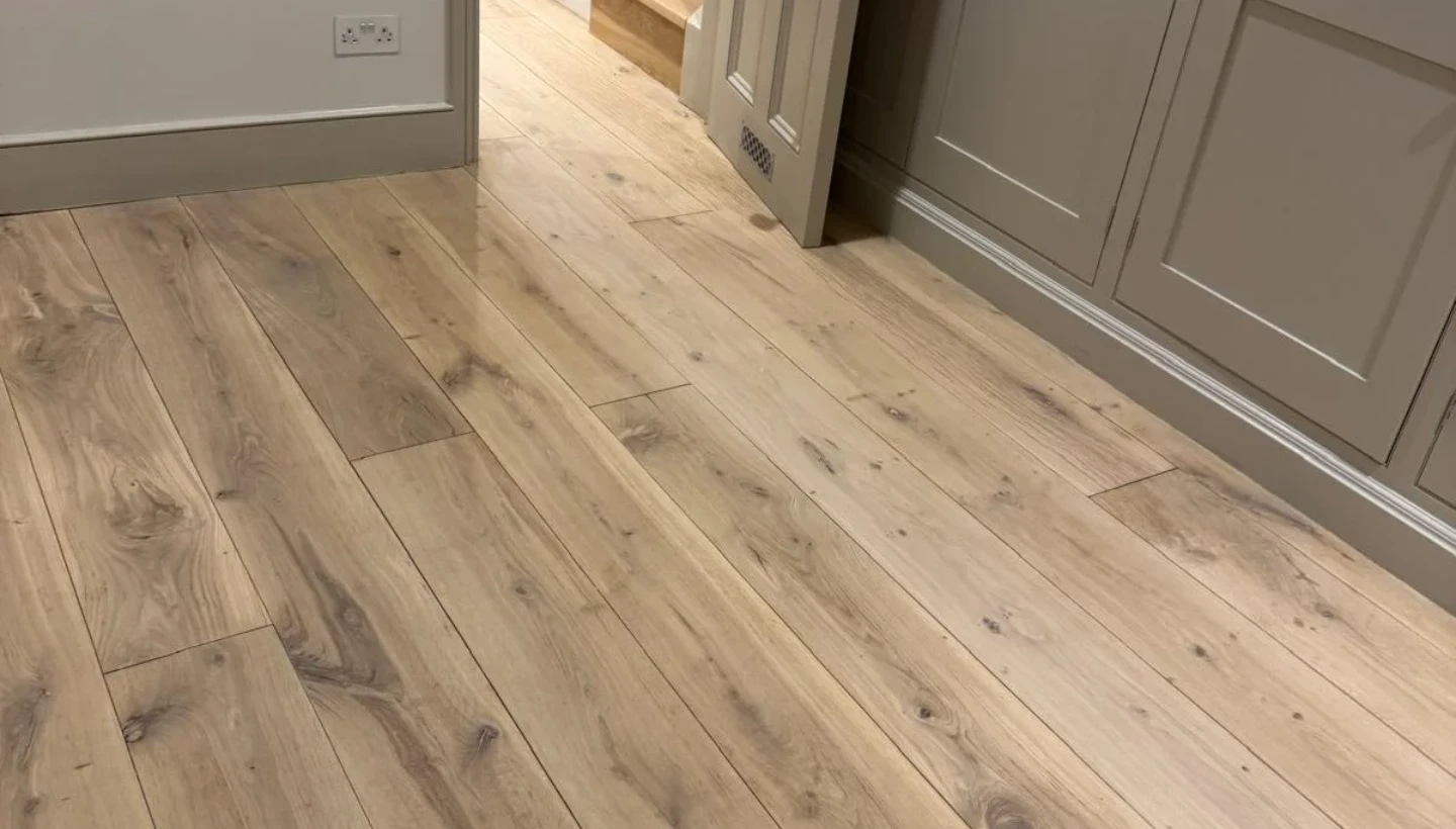 Restored oak flooring with a subtle white finish spanning three floors in a Kensington home, showcasing seamless precision and expert craftsmanship.
