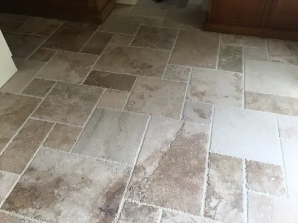 Beige and brown stone tile floor with varied rectangular pattern indoors