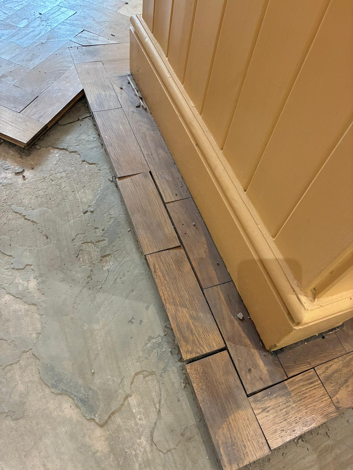 Original oak parquet blocks stacked for reuse during restoration in Angel, London